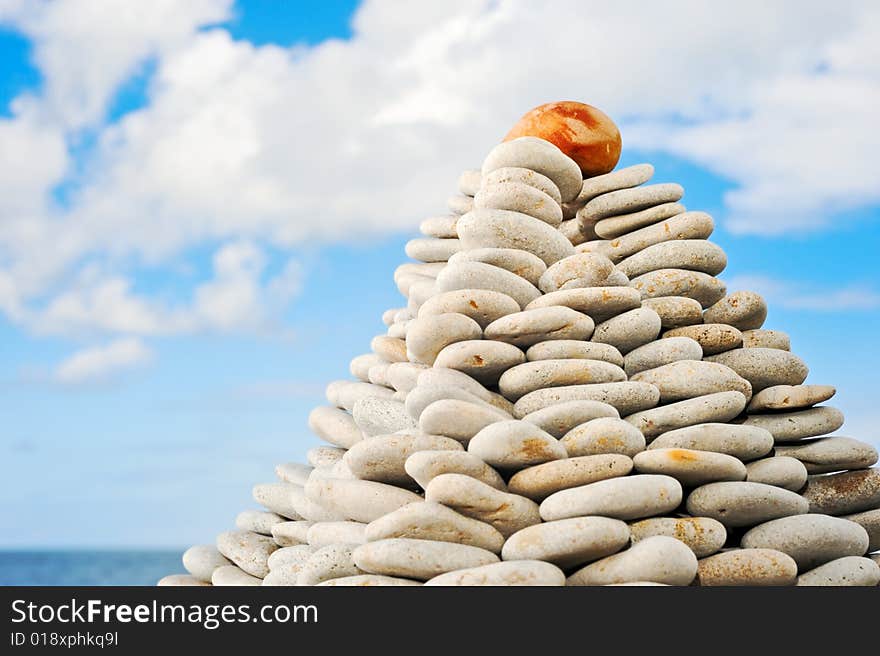 Pyramid from a pebble on seacoast in the summer. Pyramid from a pebble on seacoast in the summer