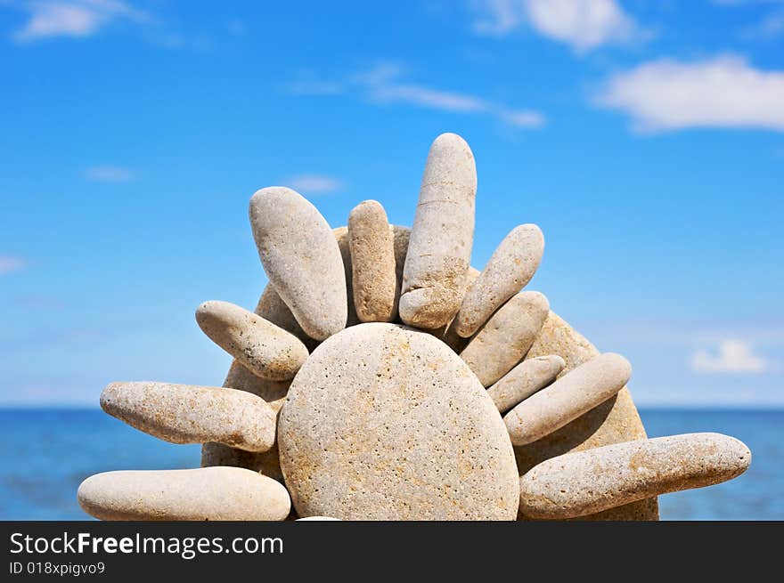 Sea pebble in the form of the sun on a beach in the summer. Sea pebble in the form of the sun on a beach in the summer