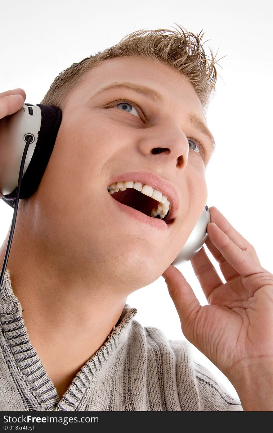 Young man with headphone on an isolated background