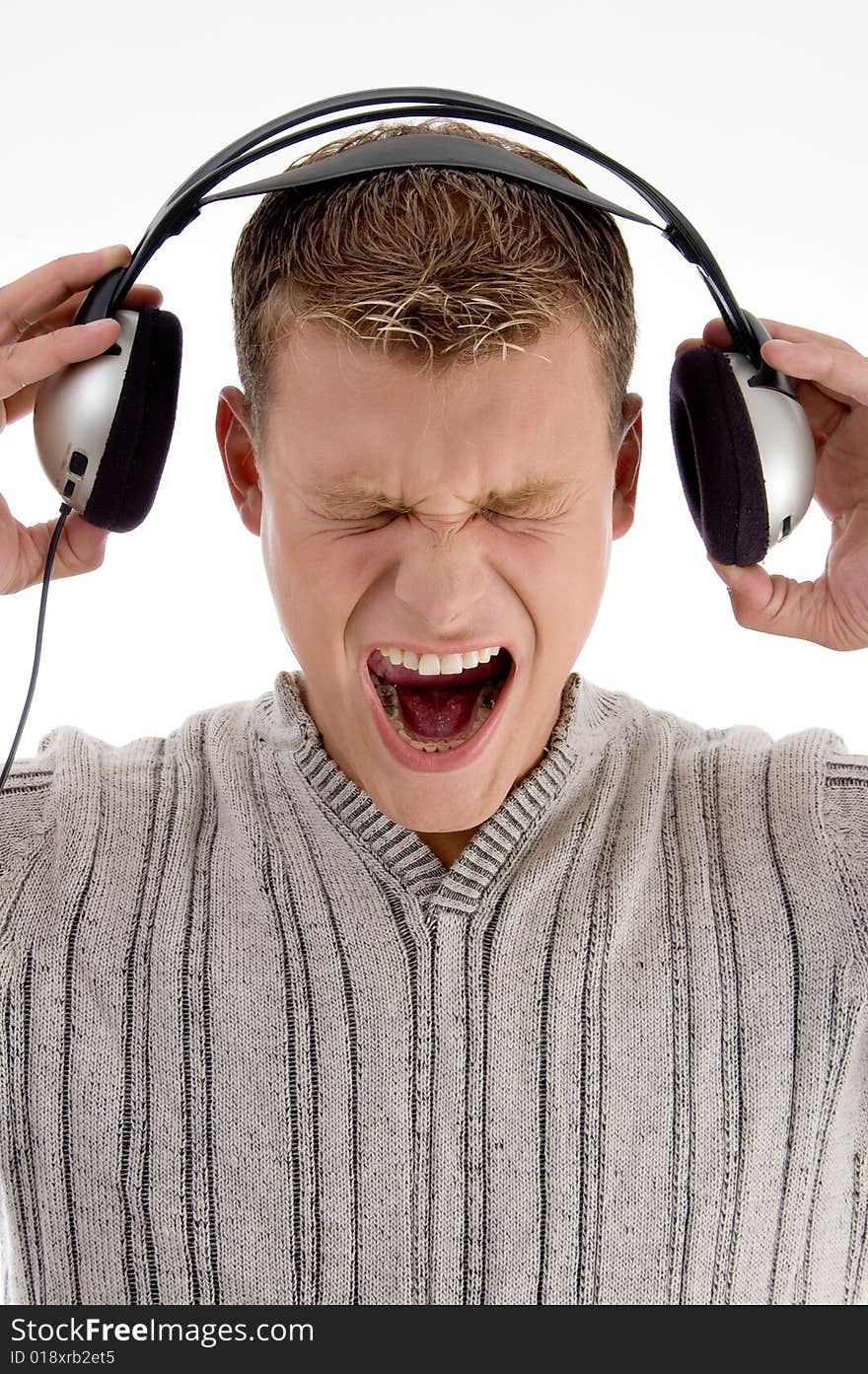 Shouting young man holding the  headphone with white background