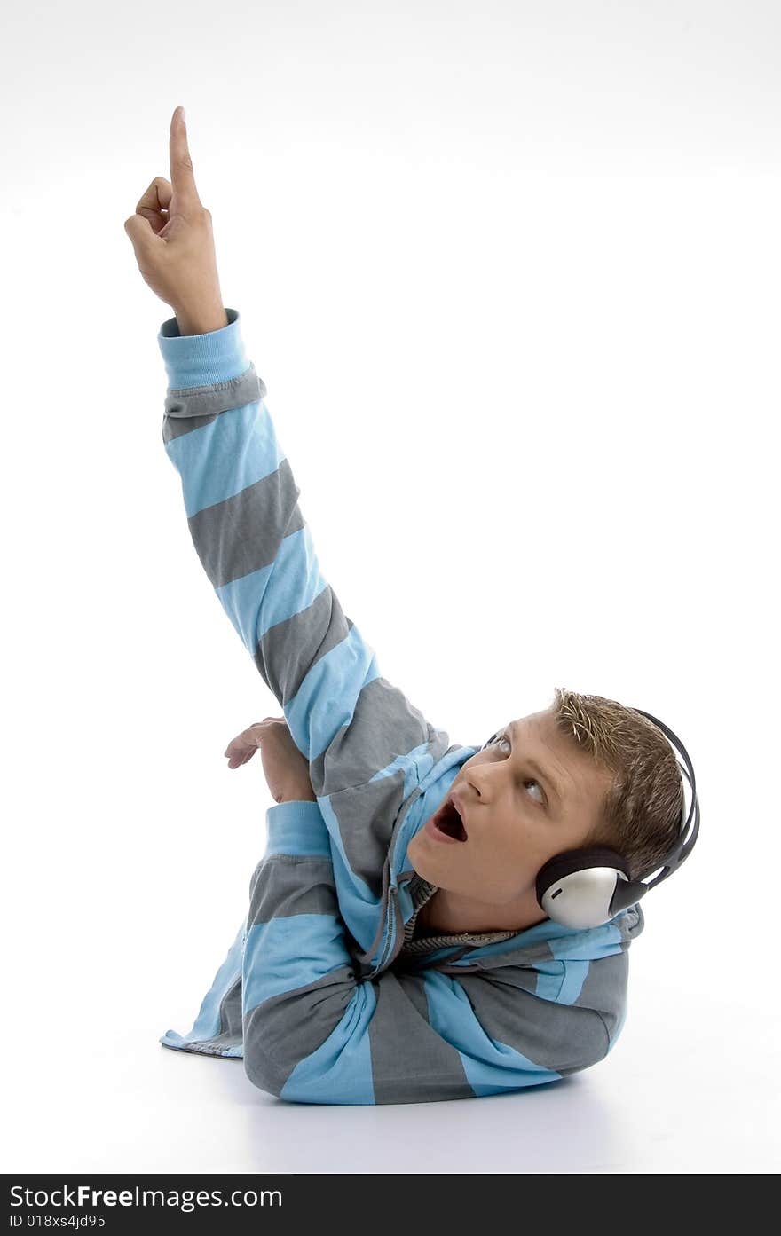 Laying young man with headphone indicating upward