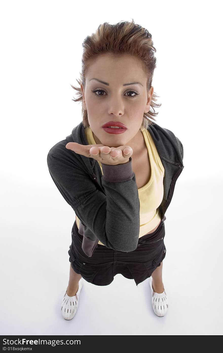 Standing glamorous female sending a kiss on an isolated white background