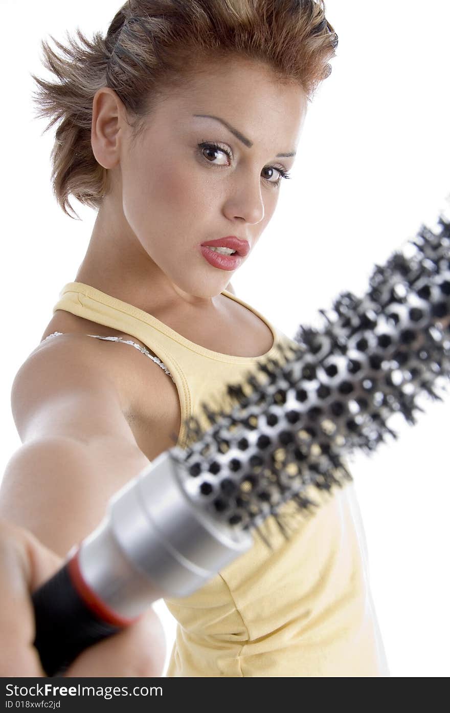 Woman posing with roller comb on an isolated background