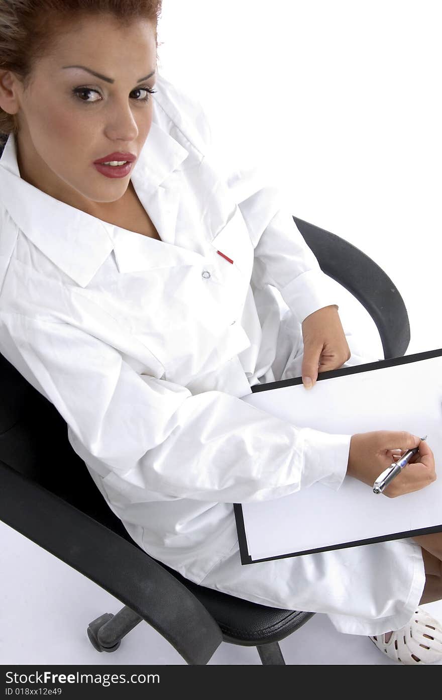 Doctor sitting with writing board against white background. Doctor sitting with writing board against white background