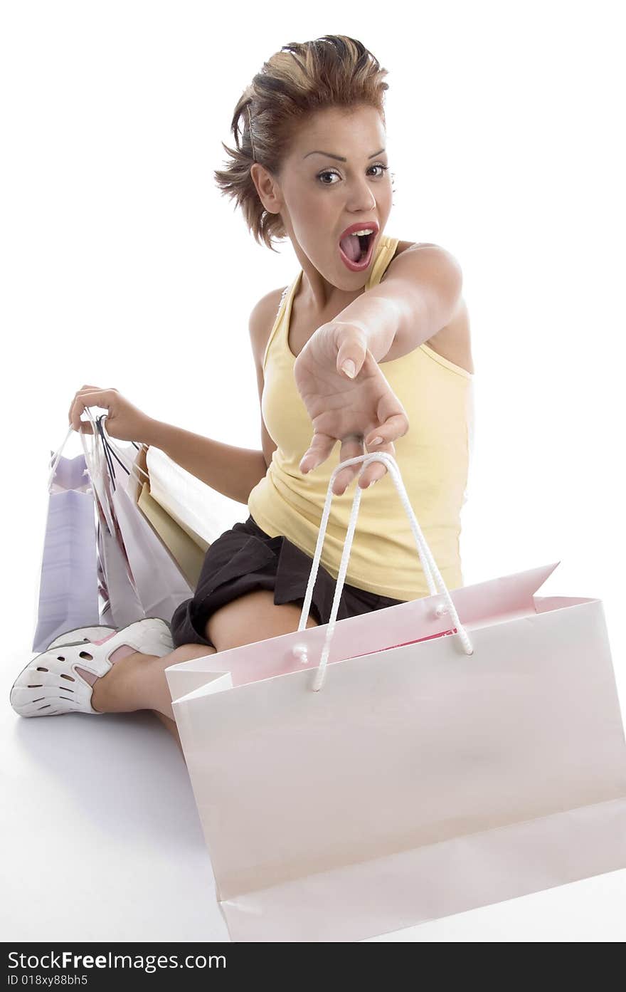 Sitting sexy woman showing shopping bags