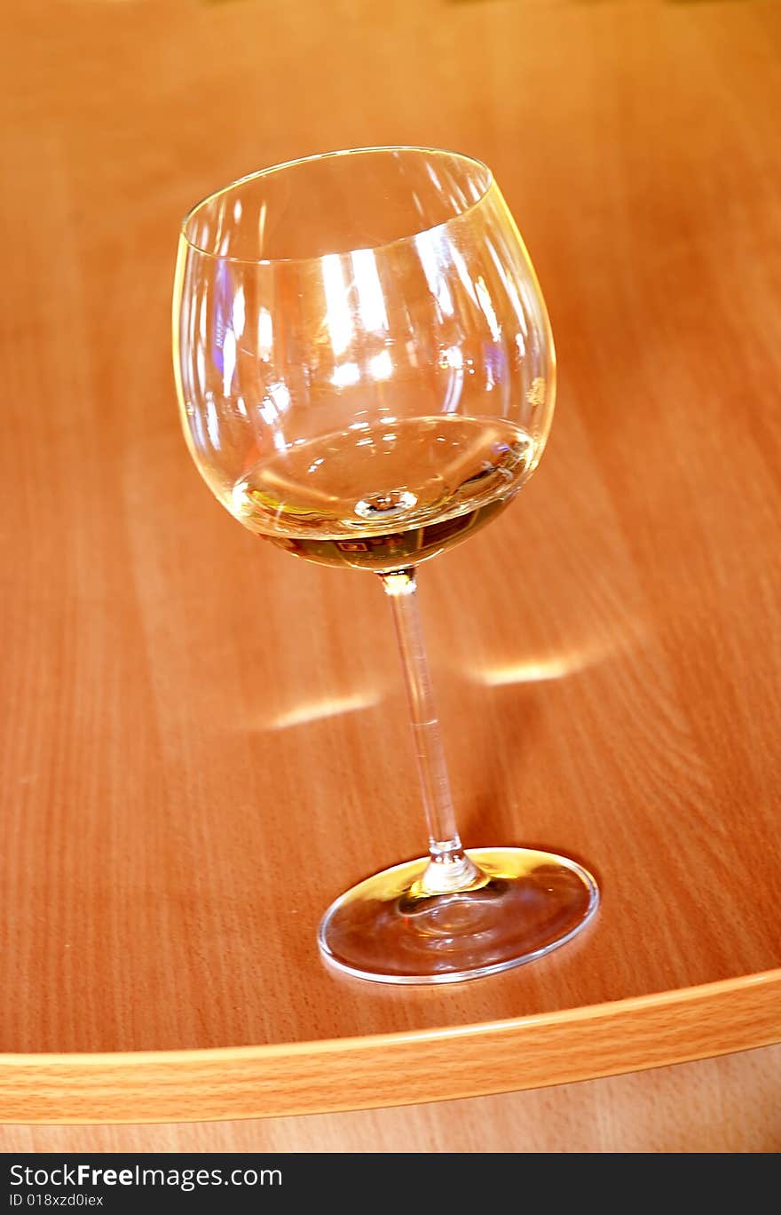 Wine glass with wine on orange wood background. Wine glass with wine on orange wood background