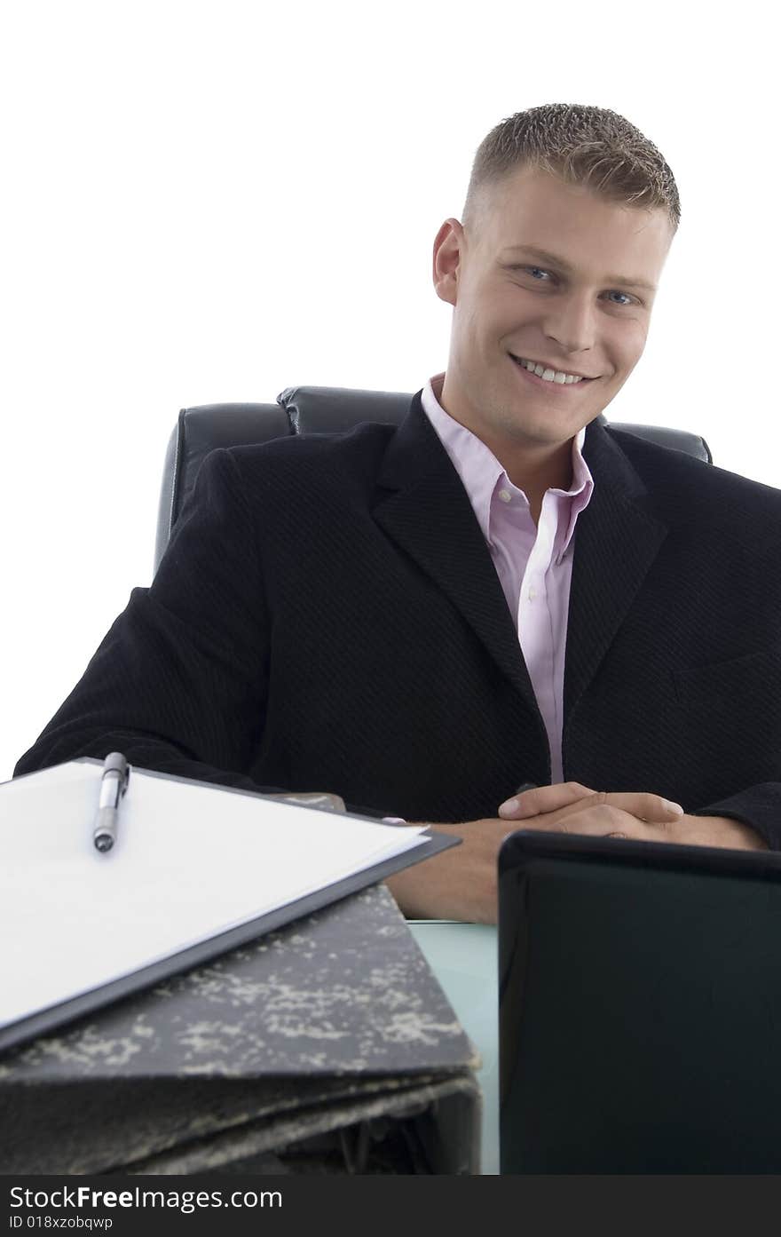 Smiling businessman looking at you on an isolated background