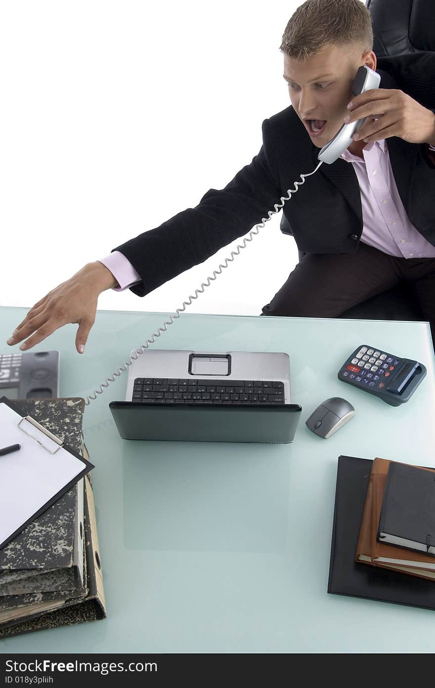 Sitting businessman busy on the phone against white background