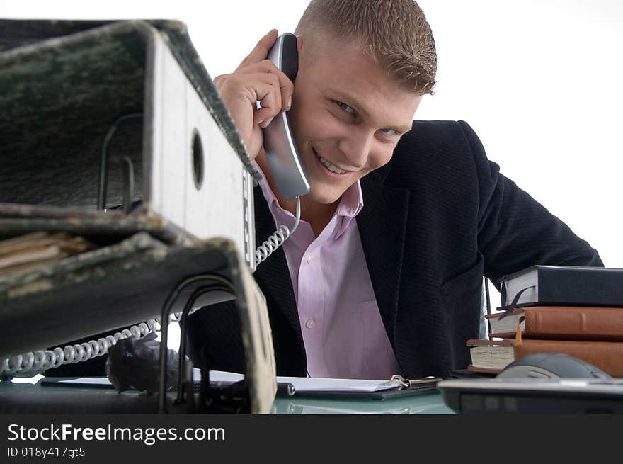 Handsome smiling manager busy on phone on an isolated white background. Handsome smiling manager busy on phone on an isolated white background