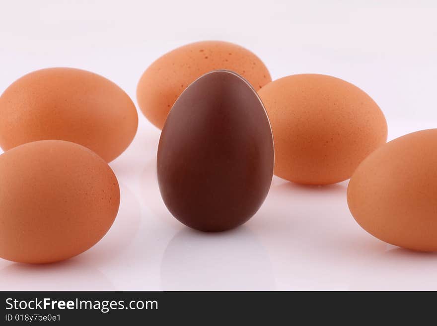 Fresh brown eggs and one Chocolate egg