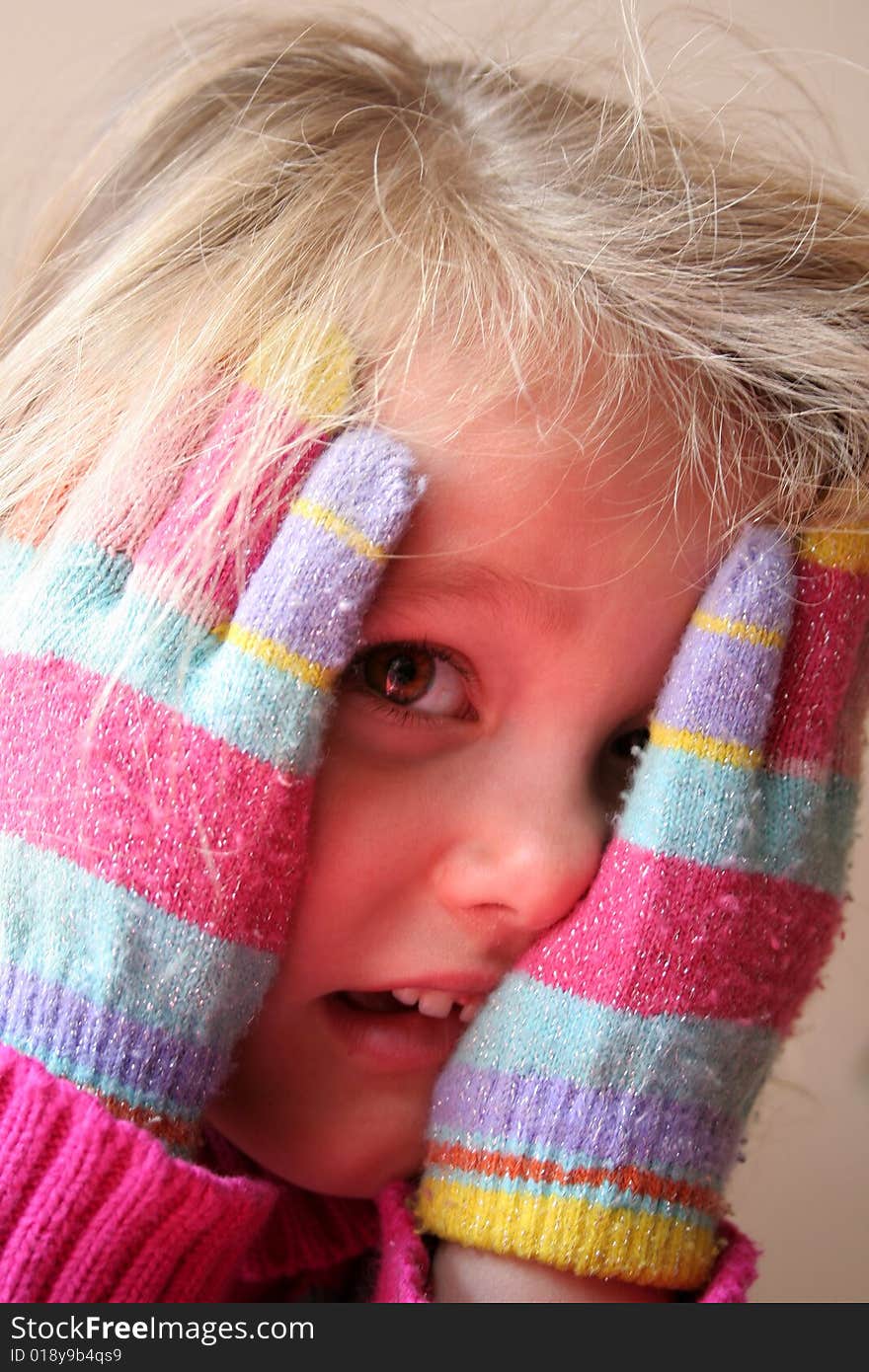 Little girl with gloves is looking nice