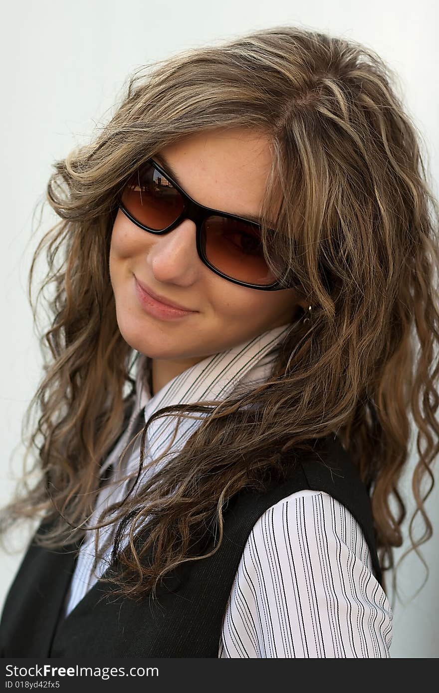 Nice young girl in the sun glassesl with a brown hair. Nice young girl in the sun glassesl with a brown hair