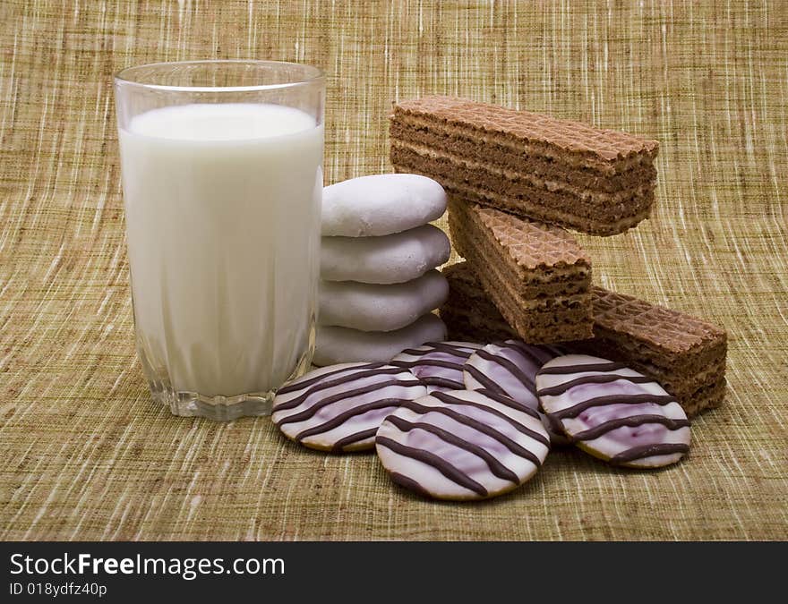 Waffle and cakes with milk close-up isolated on tissue background