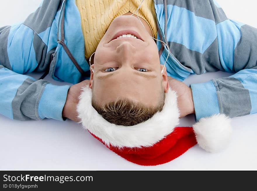 Laying smiling man with christmas hat on an isolated white background