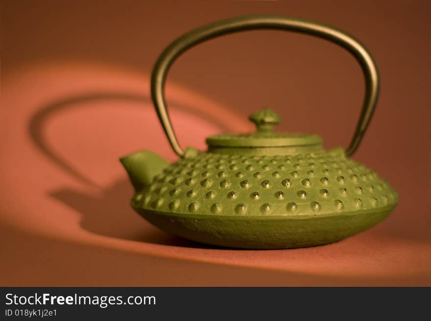 Teapot close-up isolated on pink background