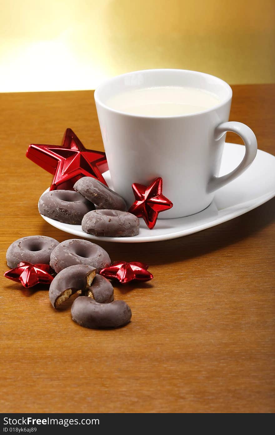 Milk and cookies for santa on table with gold background