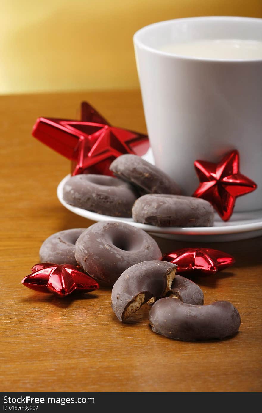 Milk and cookies for santa on table with gold background