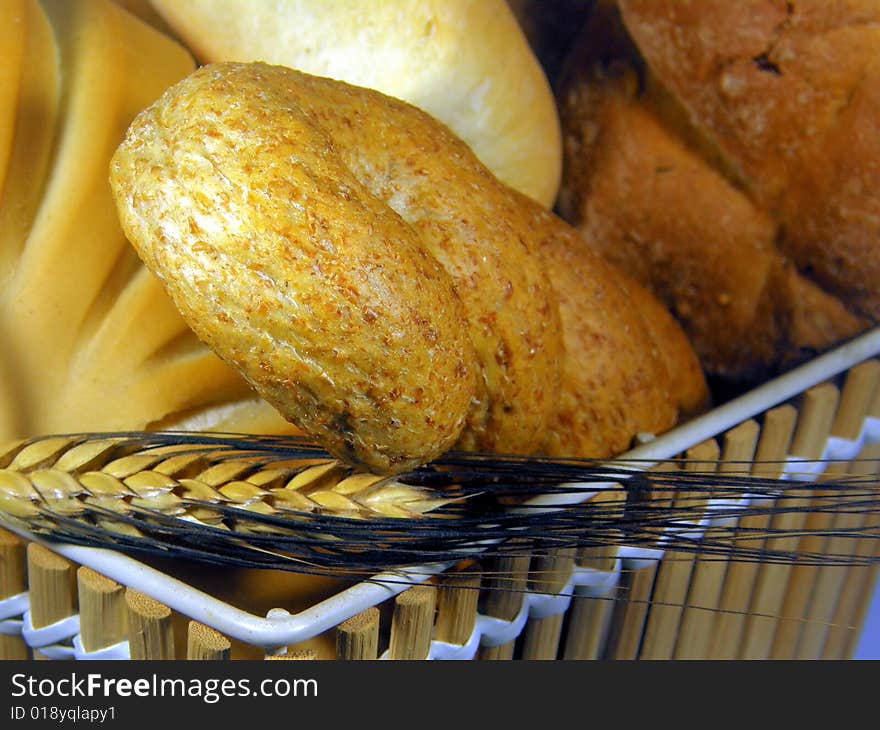 A composition of bread in a basket with an ear. A composition of bread in a basket with an ear