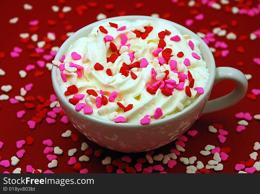 Hot cocoa with whipped cream and heart sprinkles. Hot cocoa with whipped cream and heart sprinkles