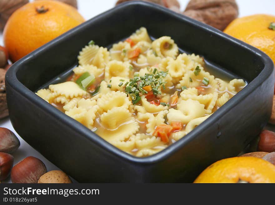 Soup of a duck with spices and pieces of oranges