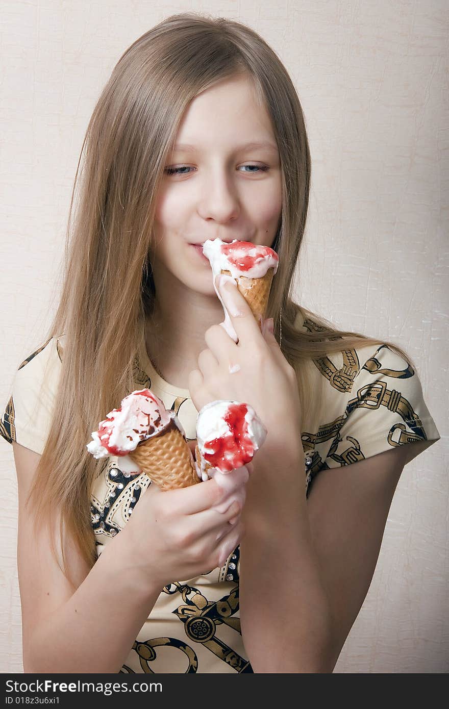 The girl - the blonde with pleasure eats ice-cream. The girl - the blonde with pleasure eats ice-cream