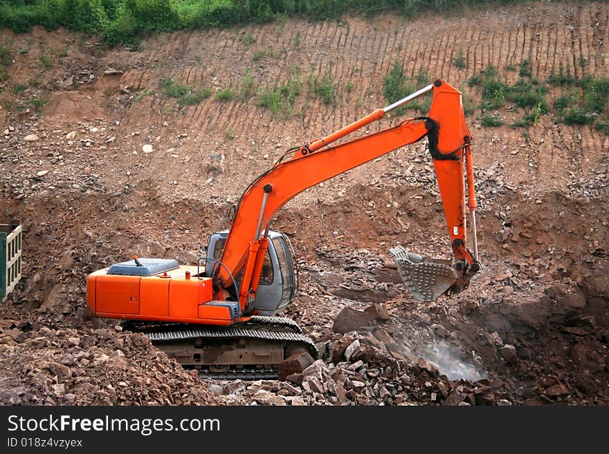 Orange excavator at construction site