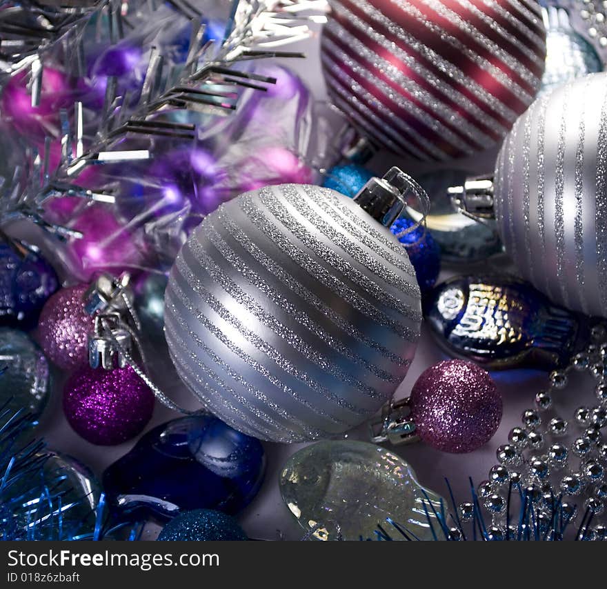 Brilliant balls against christmas ornaments.