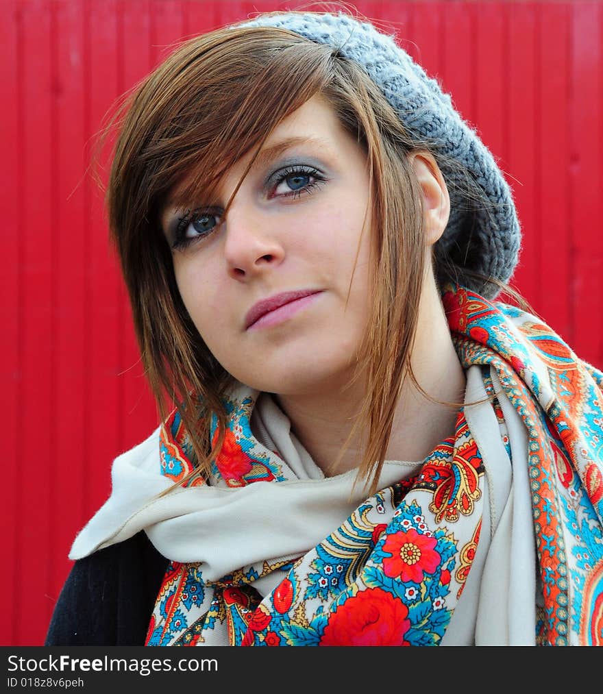 Stylish young woman against a red background