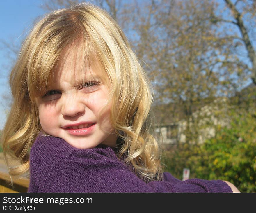 Closeup shot of a beautiful little girl playing outdoors. Closeup shot of a beautiful little girl playing outdoors.