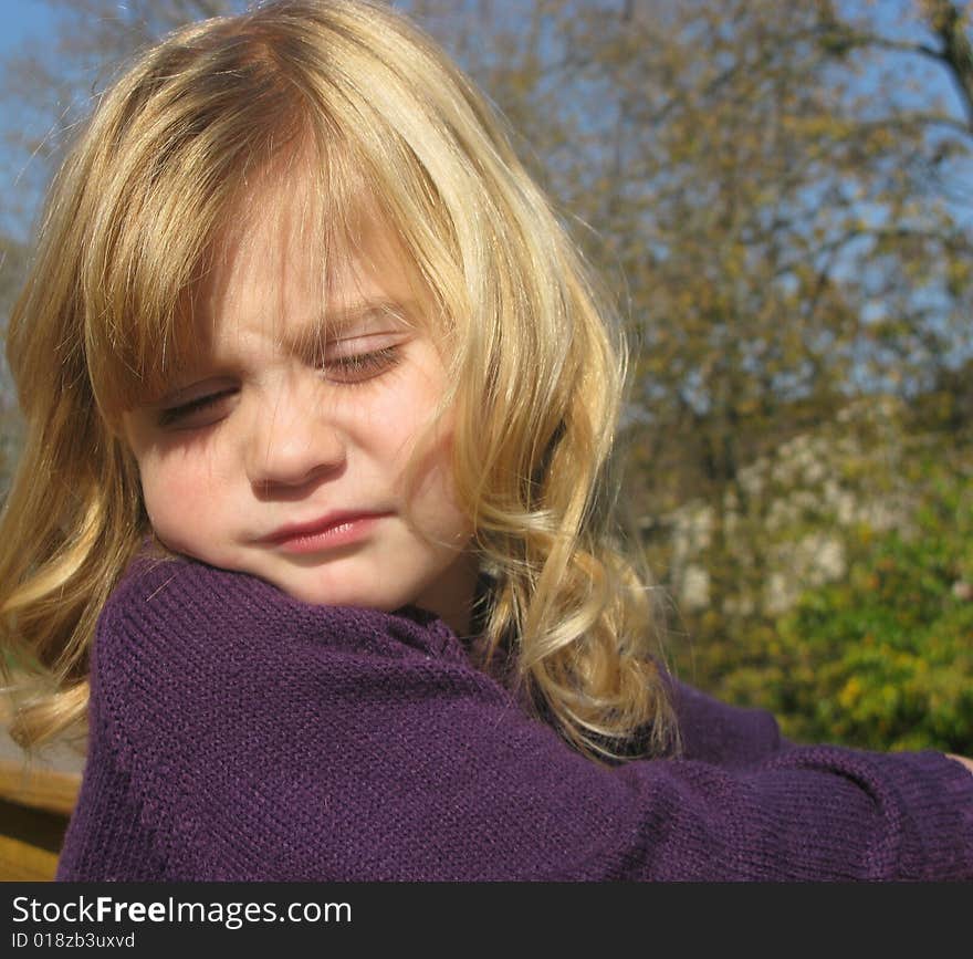 Closeup shot of a beautiful little girl playing outdoors. Closeup shot of a beautiful little girl playing outdoors.