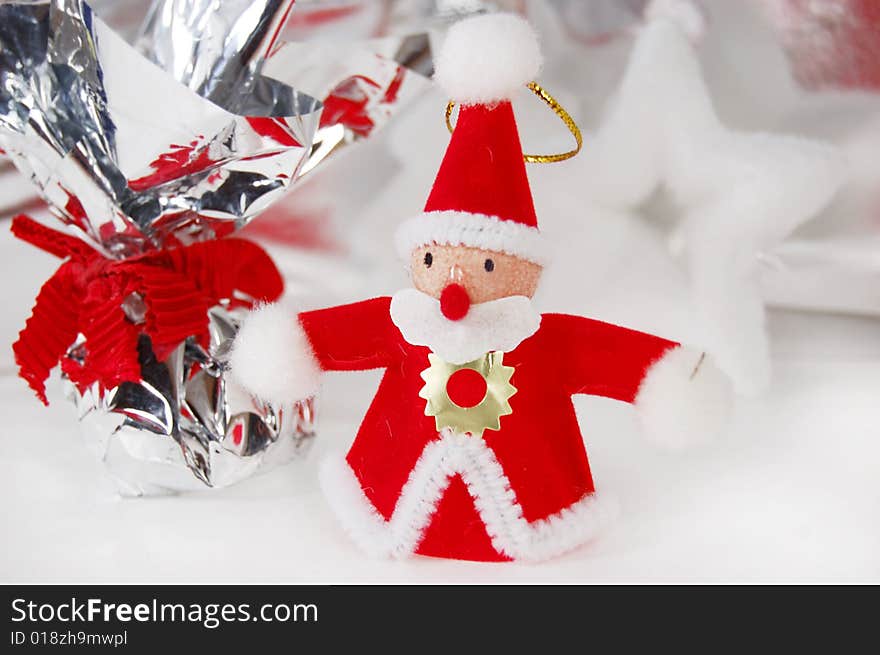 Santa claus toy with present on white