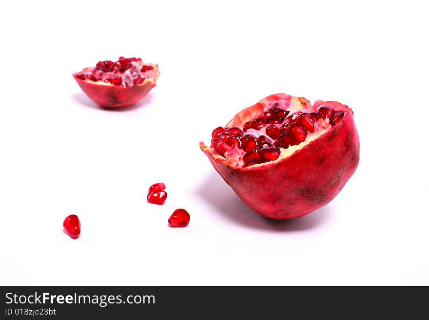 Two parts of pomegranate isolated on white. Two parts of pomegranate isolated on white