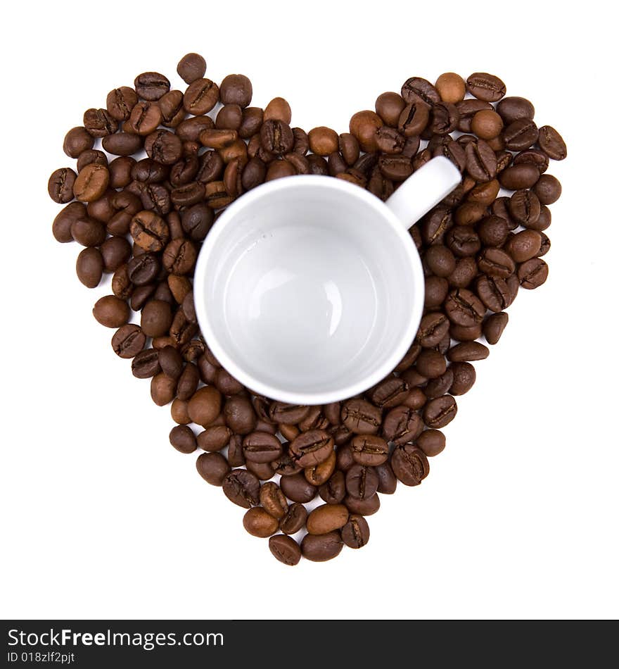 Coffee bean heart made background with cup in the middle. isolated on white background. landscape orientation.