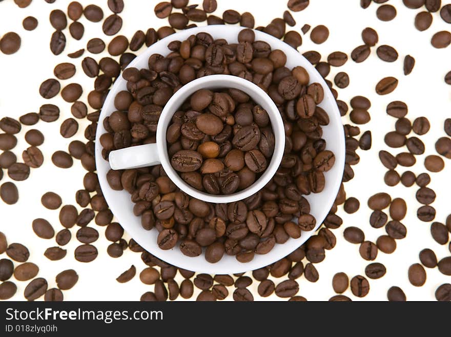 Background with white mug full of coffee beans