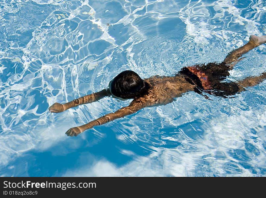 Young boy swimming on a summer day. Young boy swimming on a summer day