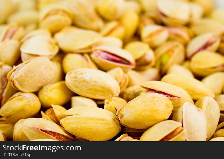 Delicious fresh pistachios background closeup