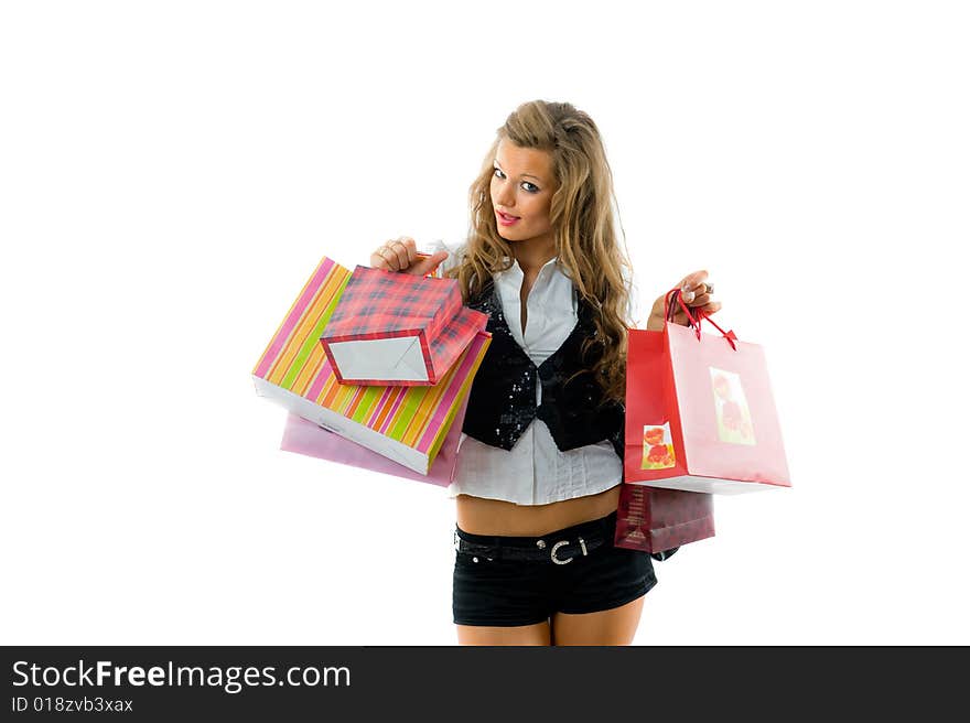 Happy young woman on a shopping paperbag.Talking by phone. Isolated on white background