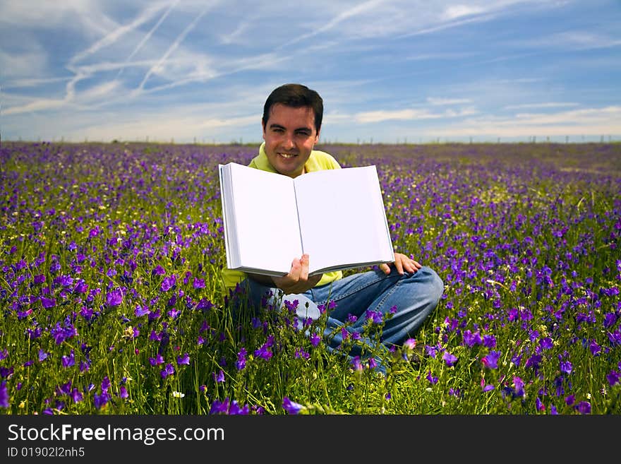 Young Man in a flied Holding Open Book with Blank Pages