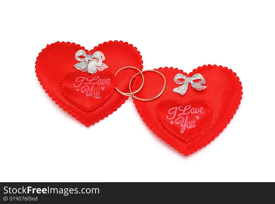 Two red hearts and wedding rings