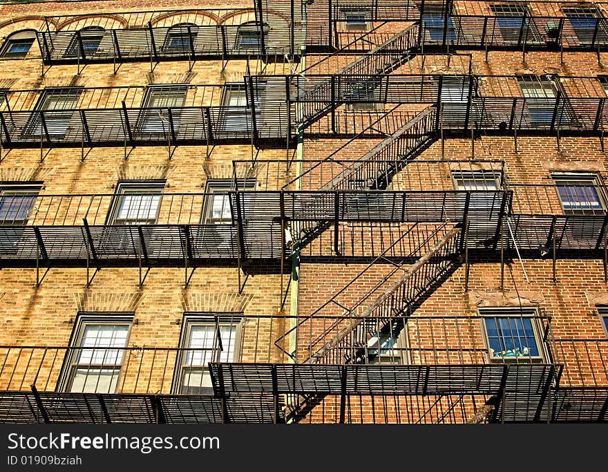 Fire escapes on old tenament buildings in boston massachusetts against a blue sky. Fire escapes on old tenament buildings in boston massachusetts against a blue sky