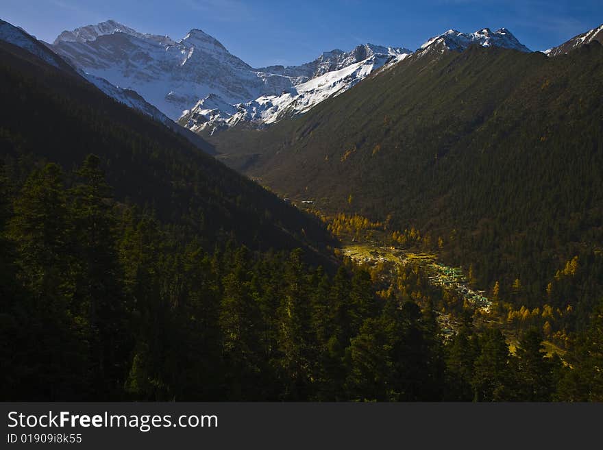 A river flows through mountains in autumn in huanglong in the west of china