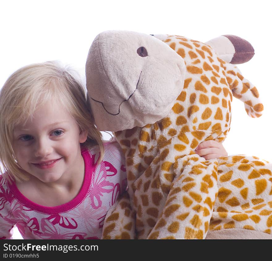 Child with stuffed giraffe in pajamas ready for bed. Child with stuffed giraffe in pajamas ready for bed