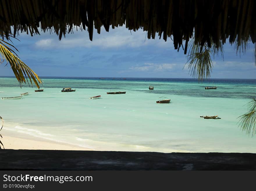 Picture taken from hut of beach and anchored boats of the coast of Africa