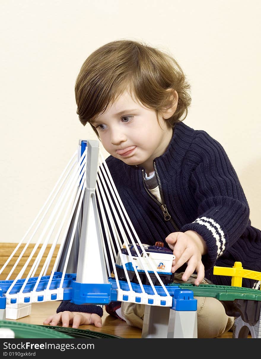 Little boy playing with train set