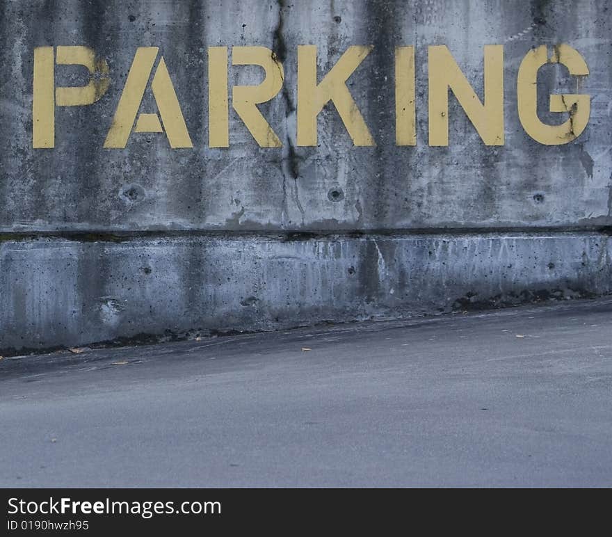 Parking sign painted on cement in yellow. Parking sign painted on cement in yellow.