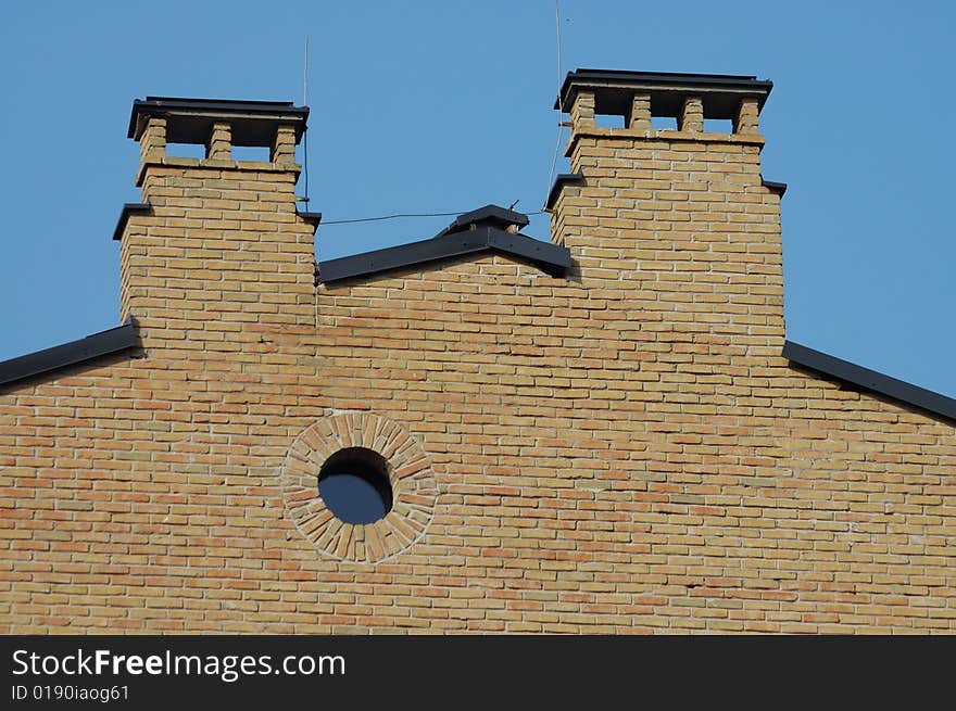 Brick house wall with circular window