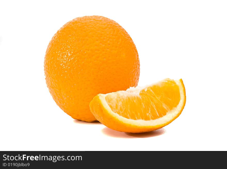 Whole and quartered oranges, isolated on white.