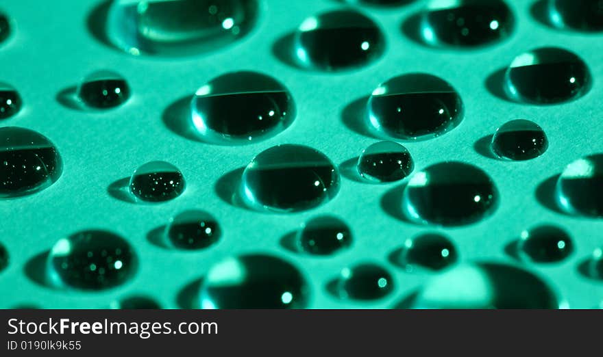 Abstract background with water drops on green glass