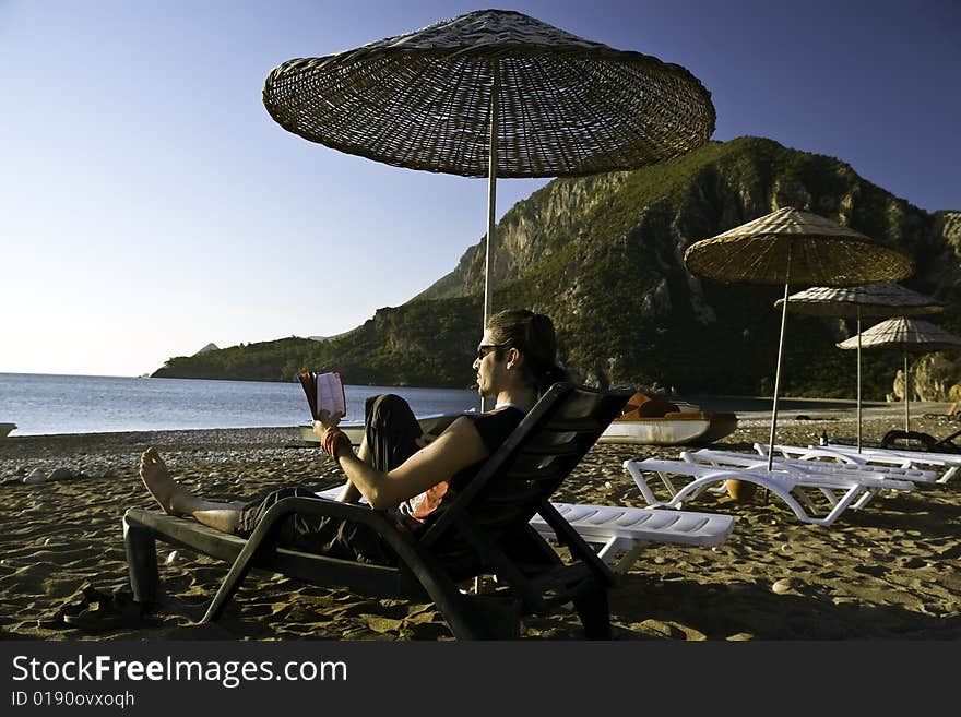 Man Sunbathing On Tropic Beach