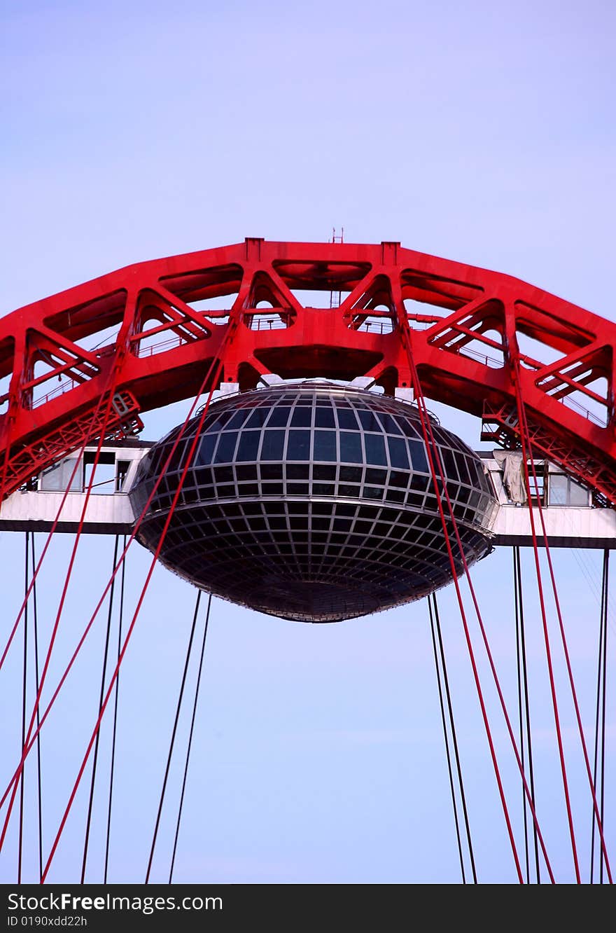 Red arch of a suspension bridge